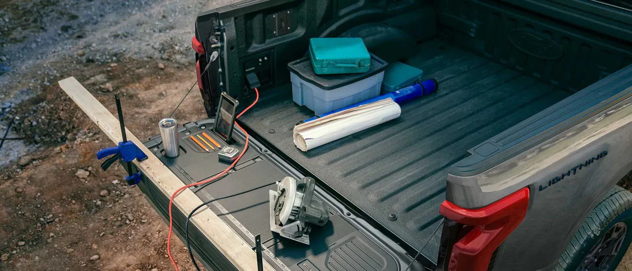 Ford F-150 Lightning Pro with work equipment in the truck bed.