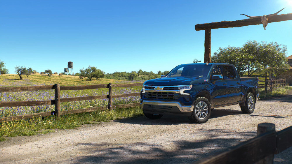 Blue Chevrolet Silverado 1500 work truck on a ranch